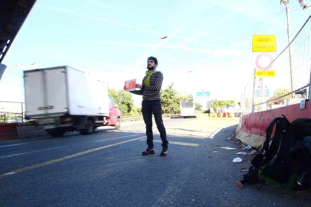 Sebastien Urbain on the first leg of his journey, as he solemnly waits for a lift from Paris to Lille.