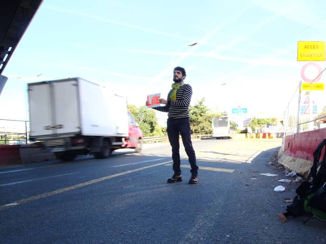 Sebastien Urbain on the first leg of his journey, as he solemnly waits for a lift from Paris to Lille.