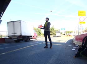 Sebastien Urbain on the first leg of his journey, as he solemnly waits for a lift from Paris to Lille.