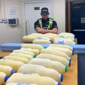 A Police Officer from Glasgow North stands over his bounty of reclaimed stolen milk.