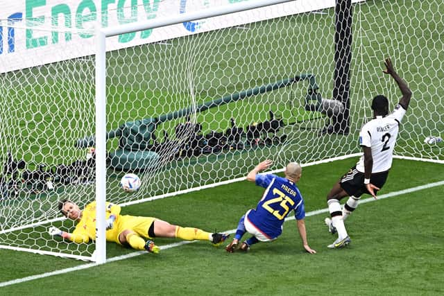 Germany’s defender Antonio Rudiger (R) raises his hand for offside after Japan’s forward Daizen Maeda (C) scored from an offside position