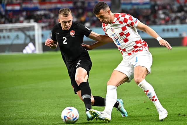 Canada’s defender Alistair Johnston (L) fights for the ball with Croatia’s midfielder Ivan Perisic (R) 
