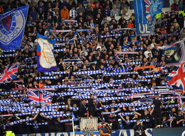 <p>Rangers' fans cheer during the UEFA Champions League Group A football match between Scotland's Rangers and Italy's Napoli at Ibrox stadium</p>