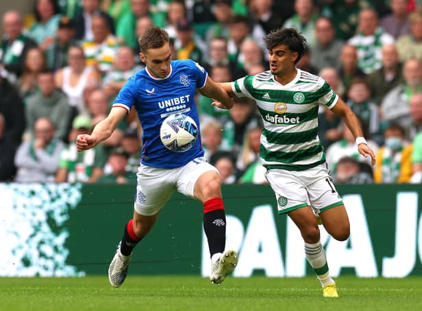 <p>Jota of Celtic battles for possession with James Sands of Rangers</p>