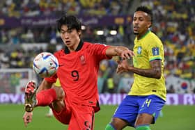 South Korea’s forward Cho Gue-sung controls the ball as Brazil’s defender Eder Militao looks on during a World Cup last-16 tie