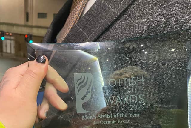 Emily McKenna holds her award for Men’s stylist of the year