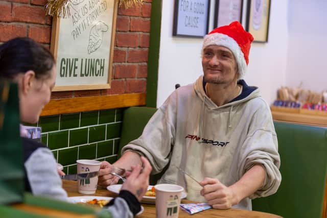 A service user enjoying a Christmas meal from Social Bite