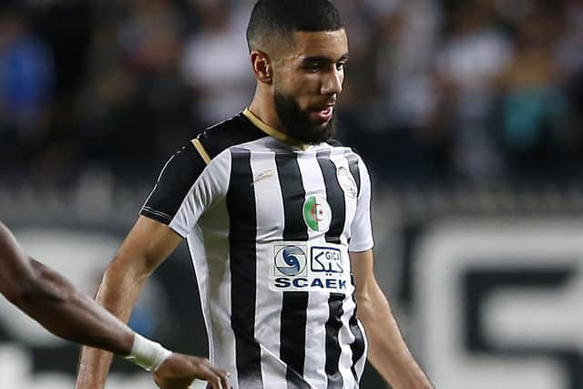 Ahly's midfielder Aliou Dieng (L) vies for the ball against Setif's forward Ahmed Kendouci (R) during the CAF Champions League Semi-Final between Algeria's ES Setif and Egypt's al-Ahly at the 5 July stadium in the Algiers suburb of Ben Aknoun 