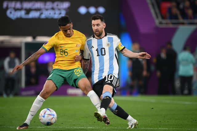 Australia’s midfielder Keanu Baccus (L) fights for the ball with Argentina’s forward Lionel Messi 