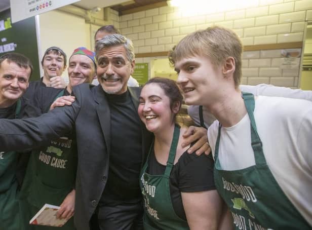<p>George Clooney poses for a selfie with Social Bite cafe staff</p>