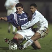 Gordon Petric of Rangers (left) tackles Franck Rabirivony of Auxerre during the champions league match