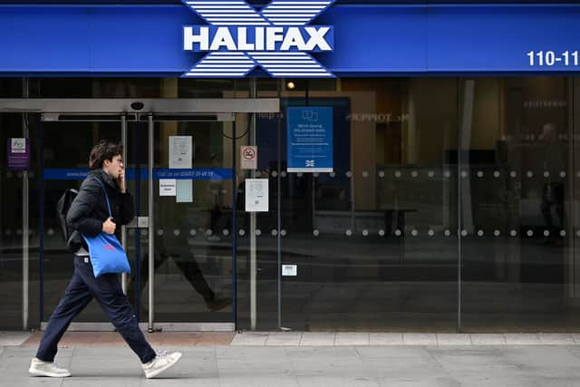 Pedestrians walk past a branch of a Halifax Building Society in central London on October 5, 2022. (Photo by Justin TALLIS / AFP) (Photo by JUSTIN TALLIS/AFP via Getty Images)