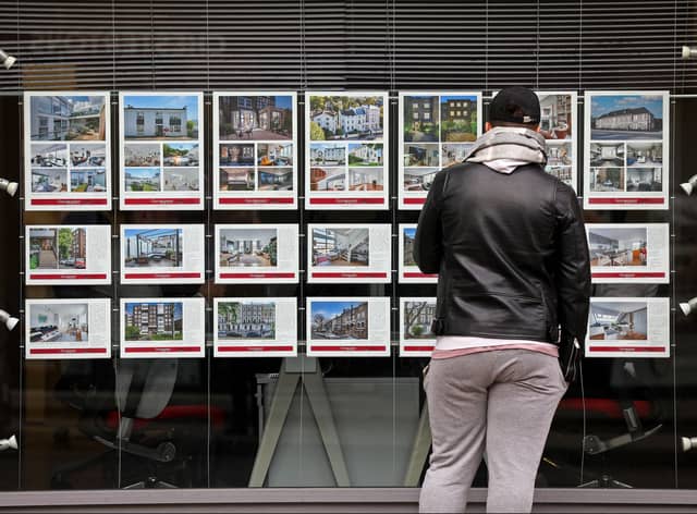 A member of the public looks at residential properties displayed for sale in the window of an estate agents' in London on September 30, 2022. (Photo by ISABEL INFANTES / AFP) (Photo by ISABEL INFANTES/AFP via Getty Images)