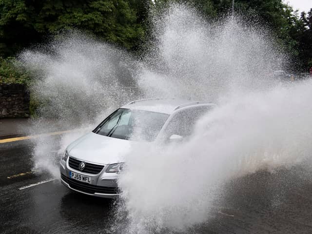 A car drives through floodwater (Photo by Matthew Horwood/Getty Images)