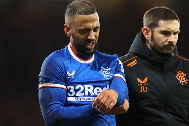 Kemar Roofe of Rangers leaves the pitch injured after landing on his shoulder