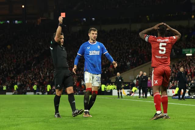  Referee Nick Walsh shows a red card to Anthony Stewart of Aberdeen after a foul on Fashion Sakala