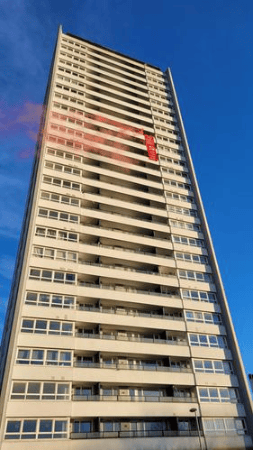 <p>Activists set off flares and unfurled a banner from the Wyndford tower that read: ‘Homes for People Not for Profits. Save the High Flats’</p>