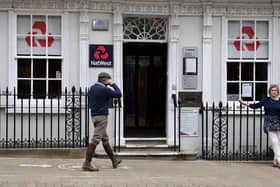 Customers use a NatWest bank on the High Street in Winchester, south west England on March 31, 2021. (Photo by ADRIAN DENNIS / AFP) (Photo by ADRIAN DENNIS/AFP via Getty Images)