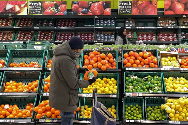 A customer shops for food items inside a Tesco supermarket store in east London on January 10, 2022.  (Photo by DANIEL LEAL/AFP via Getty Images)