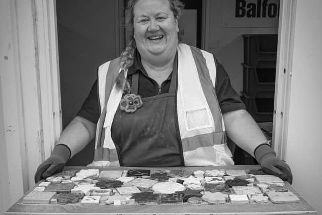 Louise, a volunteer in Maryhill, poses with her baked treats for the community