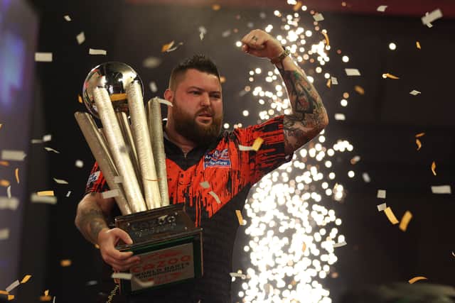 England’s Michael Smith poses for a photograph with the Sid Waddell trophy after his victory in the PDC World Championship darts final in London last month