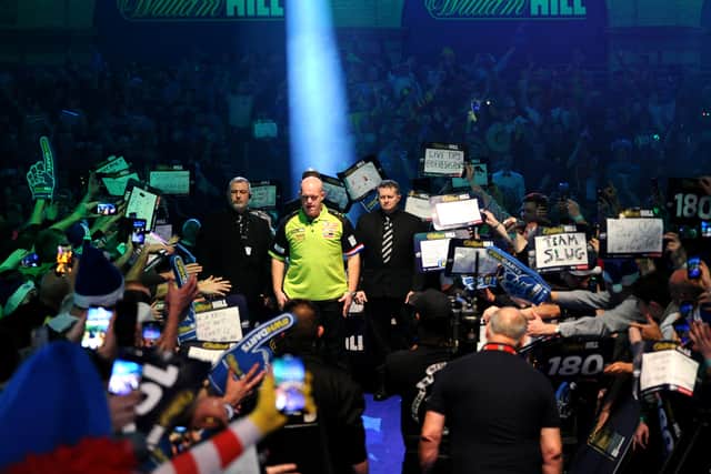 Michael van Gerwen looks on as he is introduced to the crowd 