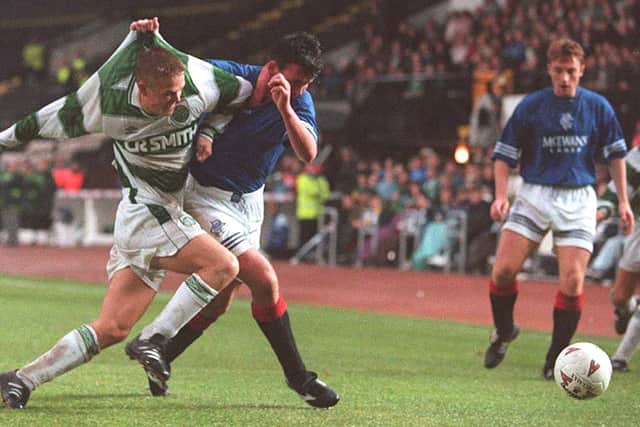 Simon Donnelly of Celtic fights for the ball with Alan McLaren of Rangers during an SPFL match in October 1994