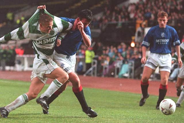Simon Donnelly of Celtic fights for the ball with Alan McLaren of Rangers during an SPFL match in October 1994