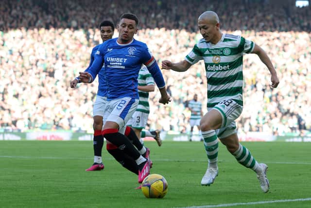  Daizen Maeda of Celtic runs with the ball while under pressure by James Tavernier of Rangers 