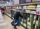 A customer shops for milk inside a Sainsbury's supermarket in east London on February 20, 2023.