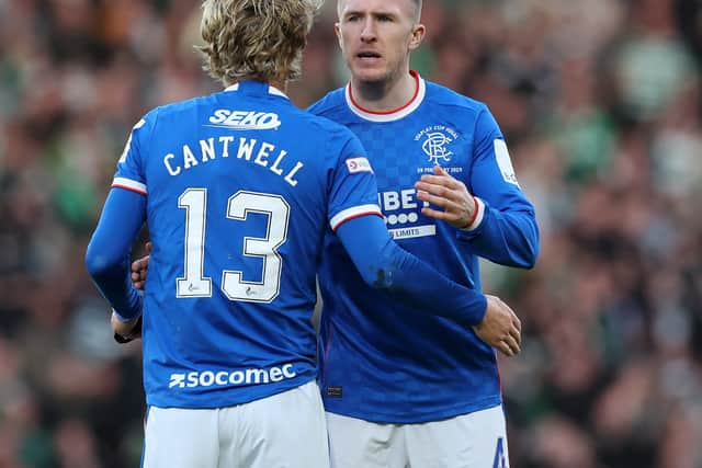 John Lundstram of Rangers embraces teammate Todd Cantwell following the team's defeat