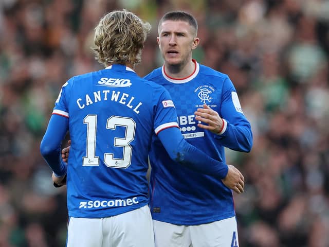 John Lundstram of Rangers embraces teammate Todd Cantwell following the team's defeat