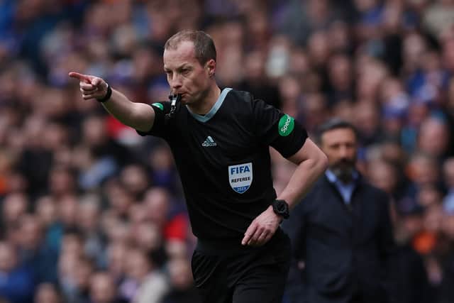 Referee Willie Collum points to the penalty spot at Ibrox