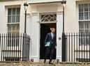 Britain's Chancellor of the Exchequer Jeremy Hunt walks out of Number 11 Downing Street 