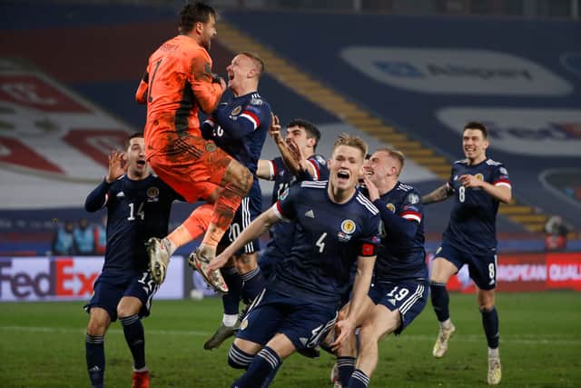 David Marshall (orange) celebrates with his team after their penalty shoot-out victory in Belgrade
