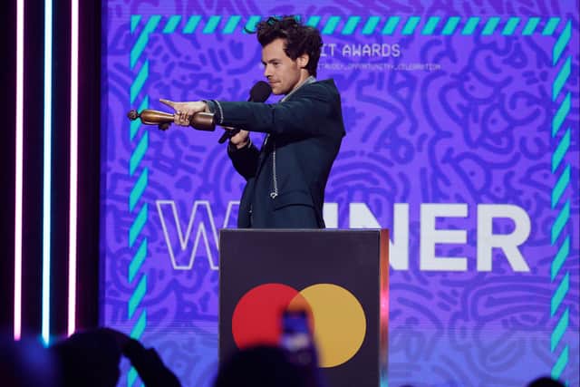 Harry Styles pointed at Lewis Capadi in the audience, as he accepted his award for best British Pop/R&B Act. A few second later Harry walked off stage towards Lewis, and they embraced. (Photo Credit: Getty Images)
