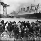 A crowd admires the nearly completed Cunard White Star liner Queen Mary at Clydebank.   (Photo by Hudson/Getty Images)