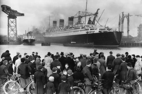 A crowd admires the nearly completed Cunard White Star liner Queen Mary at Clydebank.   (Photo by Hudson/Getty Images)