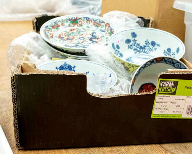 The cardboard box containing a collection of dishes including Chinese ceramics which sold for a total of £112,000.  