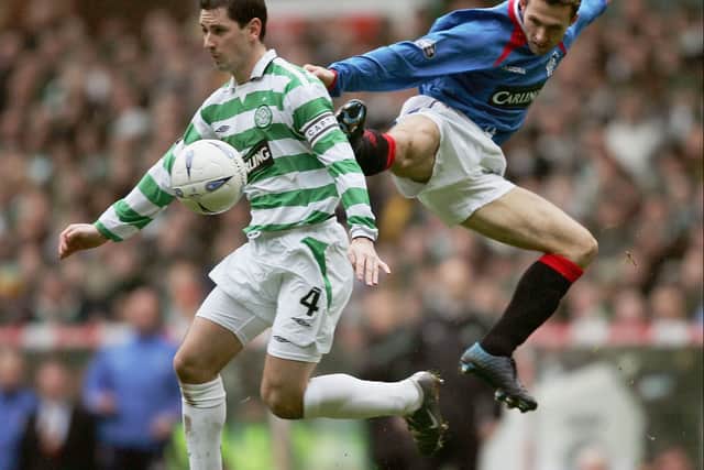 Jackie McNamara of Celtic is challenged by Thomas Buffel of Rangers during an Old Firm Scottish Cup match in 2005
