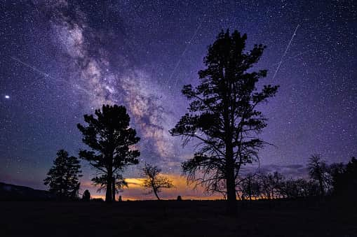 Lyrid Meteor Shower - Night astrophotography skies with light trails from streaking meteors in April.