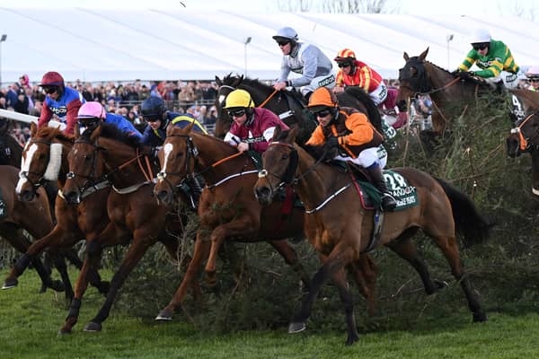 Eventual winner Noble Yeats ridden by jockey Sam Waley-Cohen (3R), rides away from The Chair in the Grand National Steeple Chase in April 2022