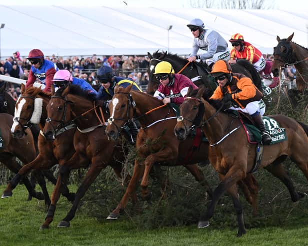 Eventual winner Noble Yeats ridden by jockey Sam Waley-Cohen (3R), rides away from The Chair in the Grand National Steeple Chase in April 2022