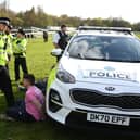 An animal rights protester is apprehended by police officers ahead of the Grand National. 