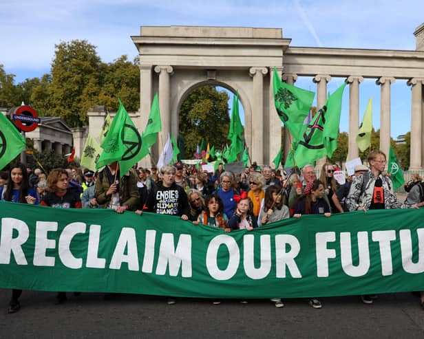 Protesters march into central London at a demonstration by the climate change protest group Extinction Rebellion, on October 16, 2022. Credit: Isabel Infantes/AFP.