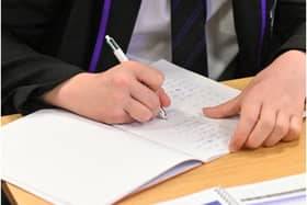 Year 11 students, wearing face coverings, take part in a GCSE maths class at Park Lane Academy in Halifax, northwest England on March 8, 2021 as schools reopen following the easing of lockdown restrictions. (Photo by Oli SCARFF / AFP) (Photo by OLI SCARFF/AFP via Getty Images)