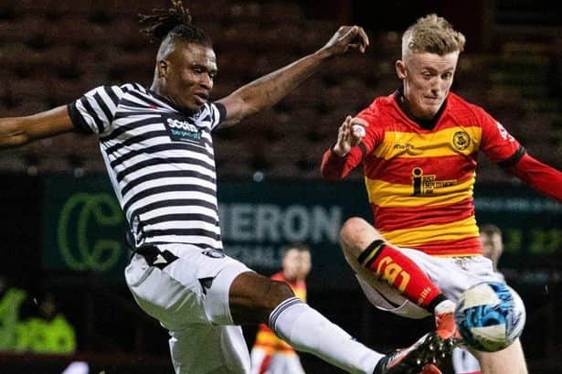Kyle Turner of Partick Thistle battles for possession with Malachi Boateng of Queen’s Park.