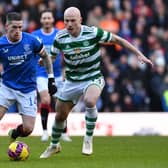 Ryan Kent of Rangers is challenged by Aaron Mooy of Celtic