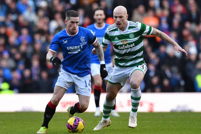 Ryan Kent of Rangers is challenged by Aaron Mooy of Celtic