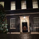 A Christmas tree stands illuminated outside number 10 Downing Street (Getty Images)